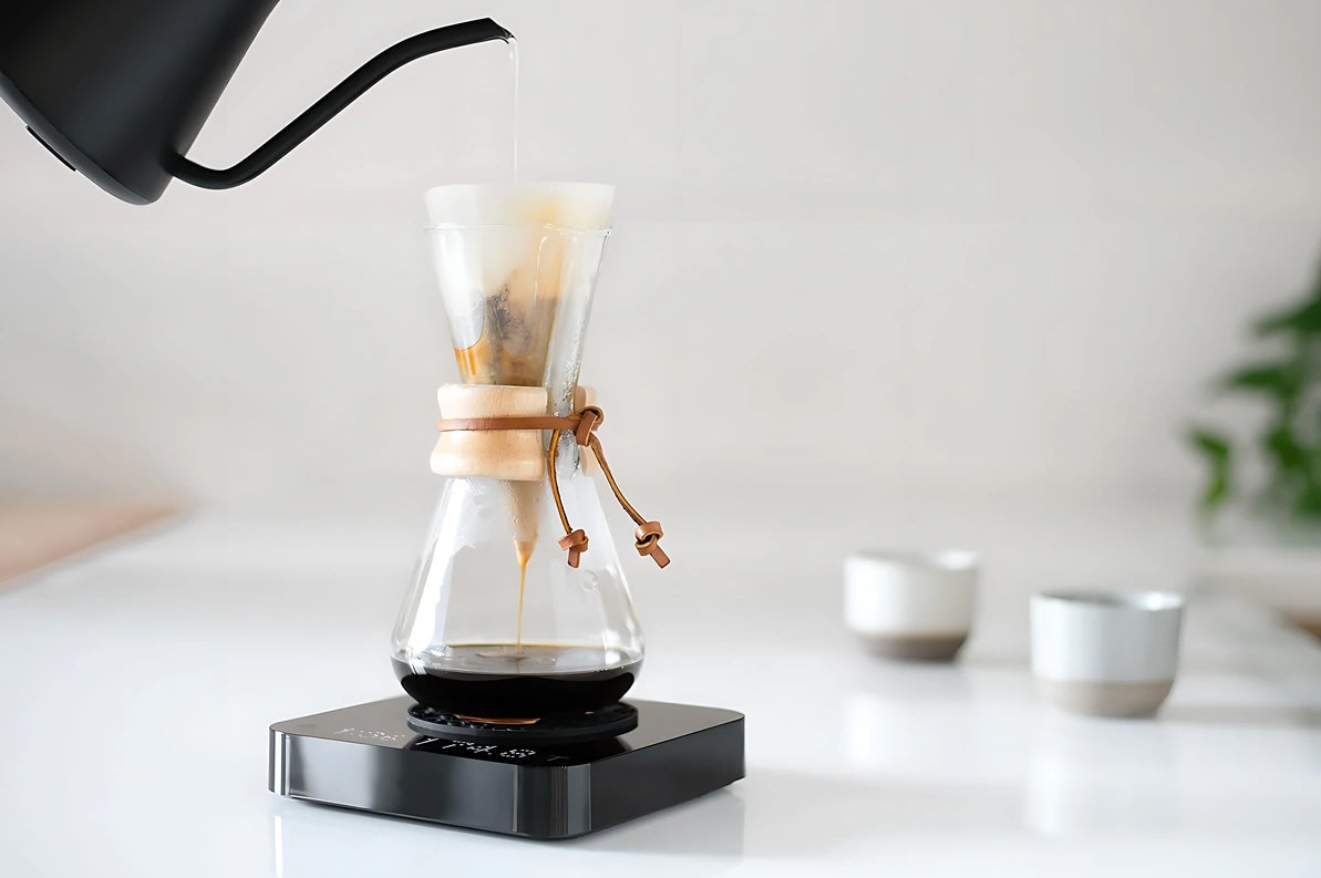Acaia Pearl S coffee scale in use during a pour-over brewing process.