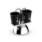 Bialetti Mini Express Induction set with two black espresso cups on stainless steel base.