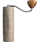 Comandante X25 Trailmaster Dune hand grinder with ergonomic design and sand-colored techno-polymer body.