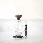 Hario Coffee Syphon Technica TCA 3 Cup on table, showcasing vacuum method for optimal aroma release.