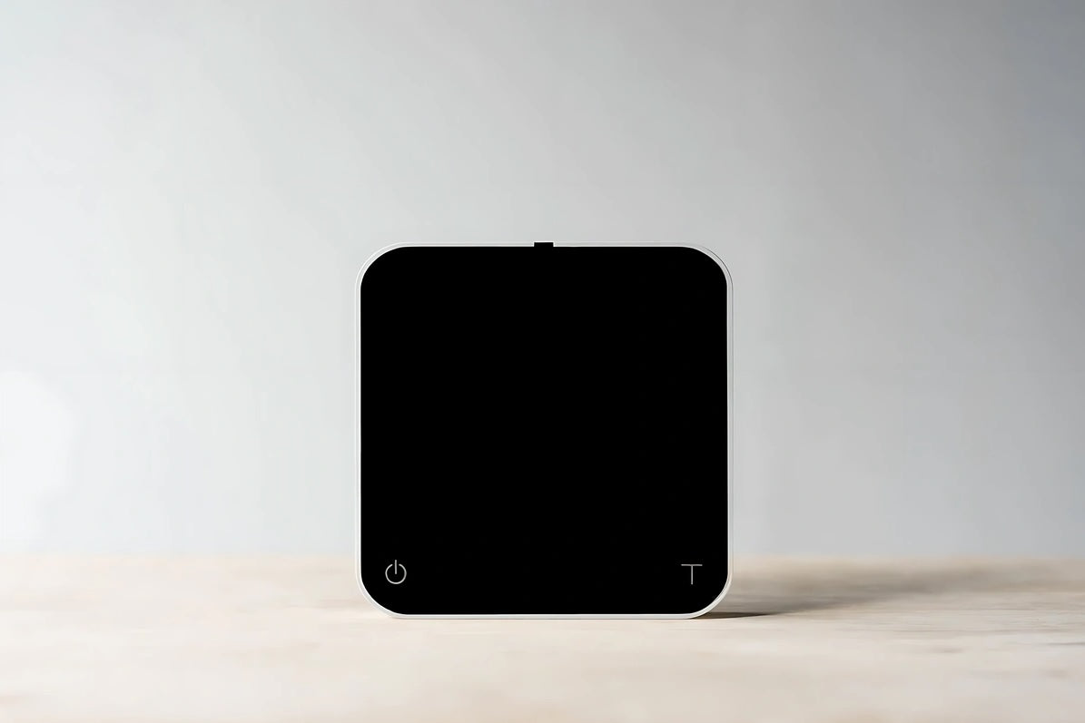 Acaia New Pearl coffee scale in black with LED display and touch-sensitive controls, designed for precision brewing.