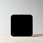 Acaia New Pearl coffee scale in black with LED display and touch-sensitive controls, designed for precision brewing.